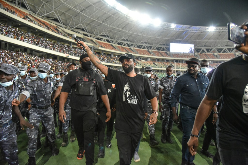 Fally Ipupa has a police escort leaving Abidjan's Olympic stadium in March last year