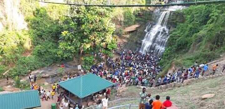 People gathered at a waterfall