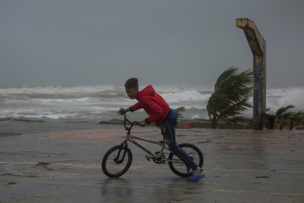 A young person rides his bicycle in Nagua, Dominican Republic, on September 19, 2022