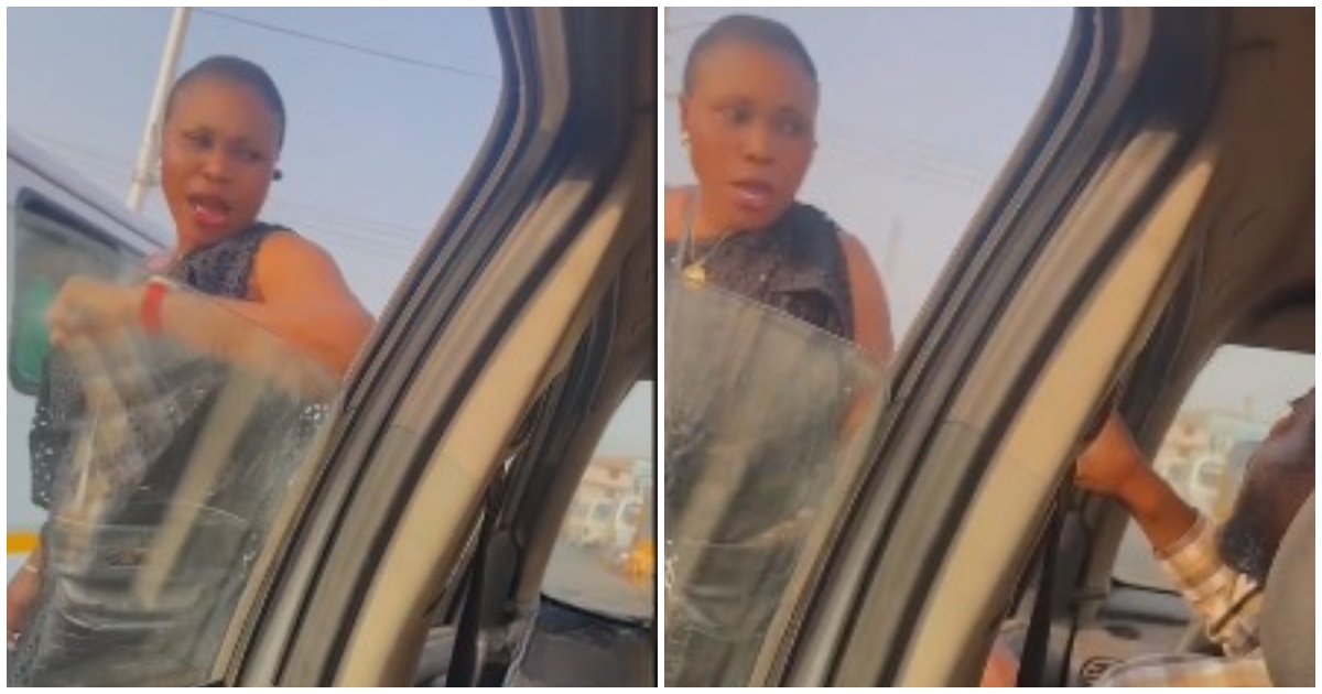 A Ghanaian woman and taxi driver arguing in the middle of the road