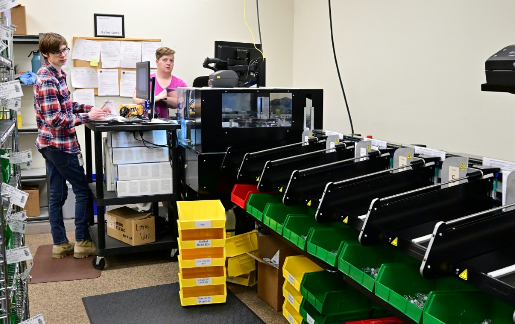 Election workers sort absentee ballots using machines before the U.S. primary in Redding, California