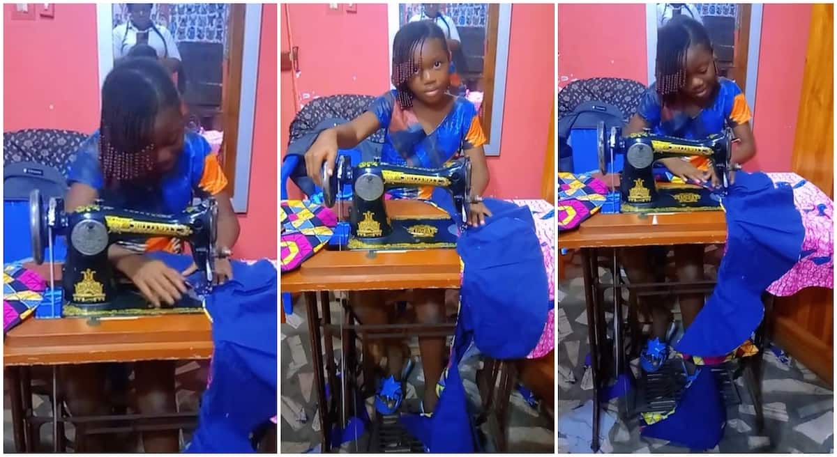 Little girl practising on a sewing machine.