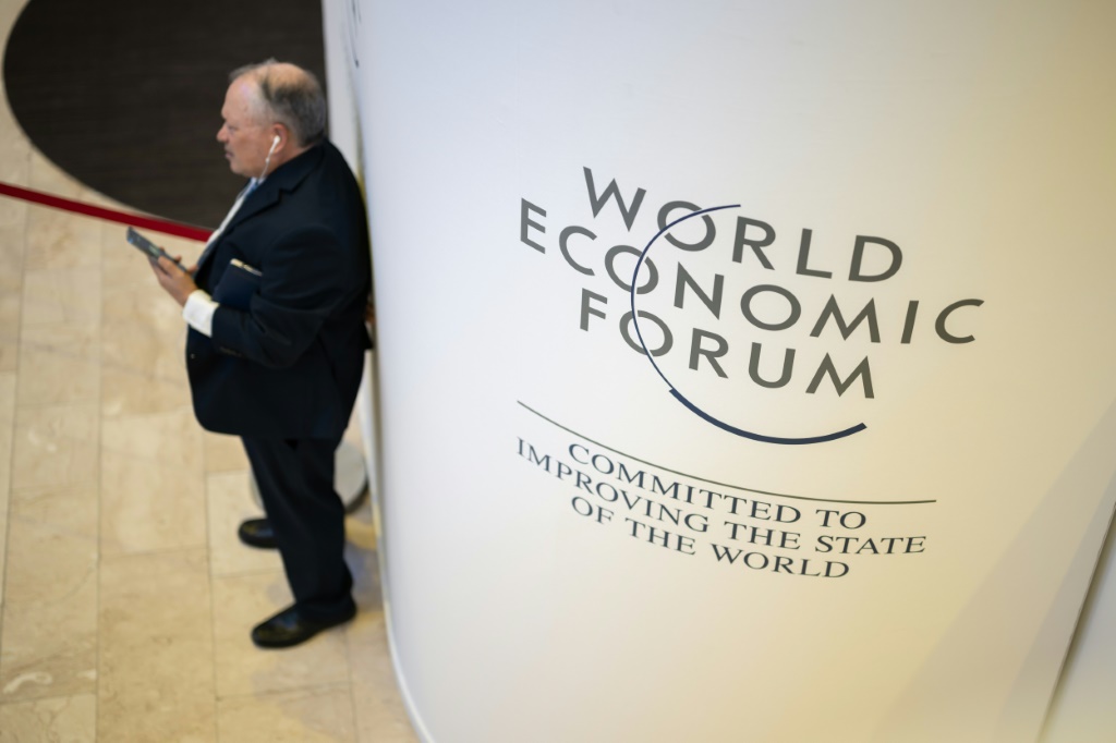 A participant uses his mobile phone at the Congress centre during the World Economic Forum (WEF) annual meeting in Davos on January 18, 2023