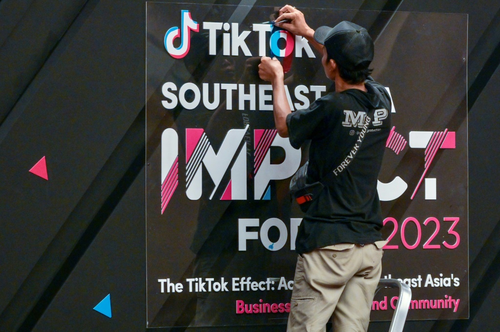 A worker finishes signage before the TikTok Southeast Asia Impact Forum 2023 in Jakarta on June 15, 2023.
