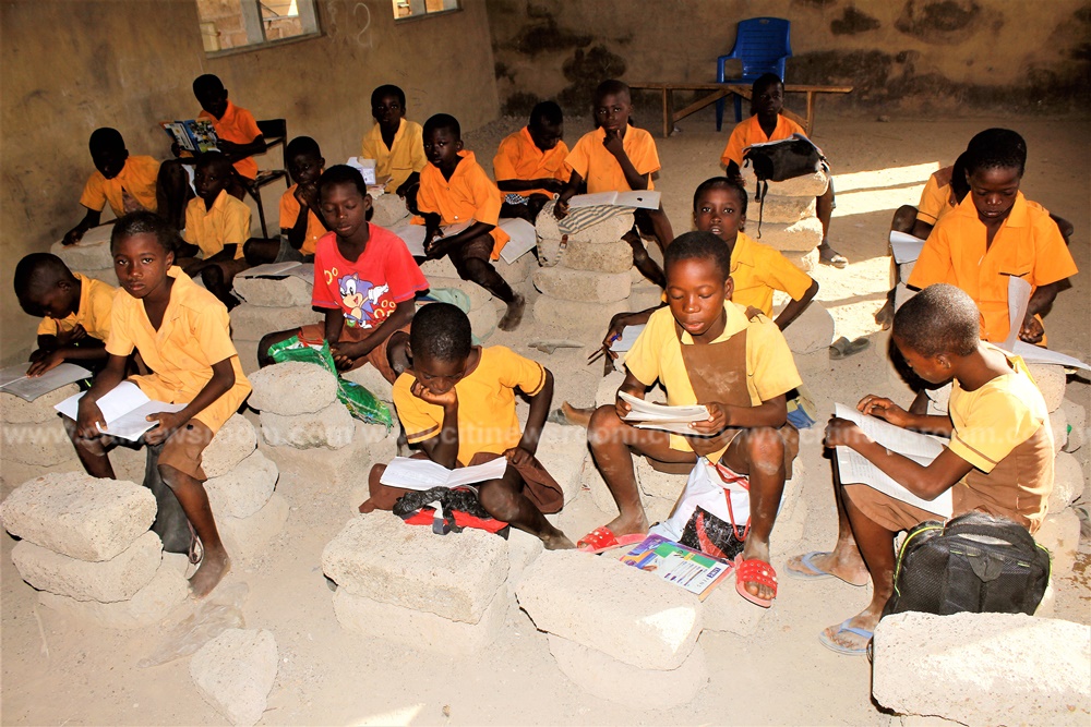 Pupils of Abolato primary use cement blocks to study