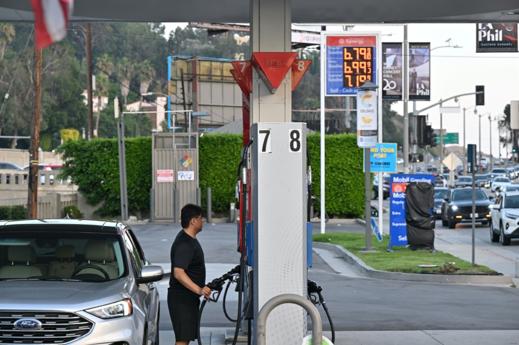 A man pumps gas at a petrol station in Los Angeles -- energy prices continue to increase in the United States