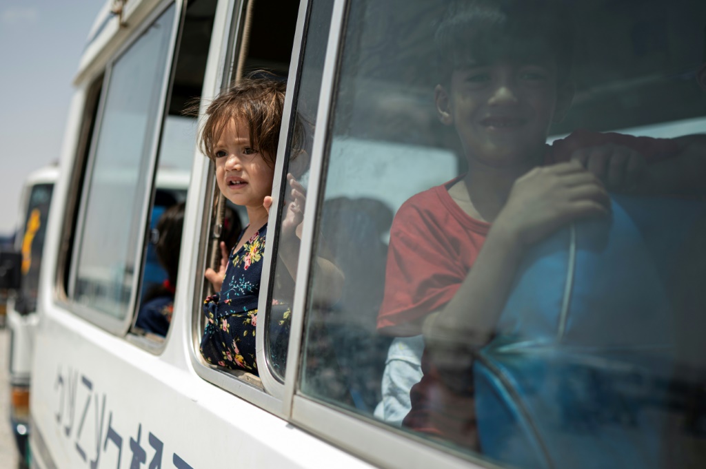 More than 30 buses were chartered to transport men, women and children back to their homes