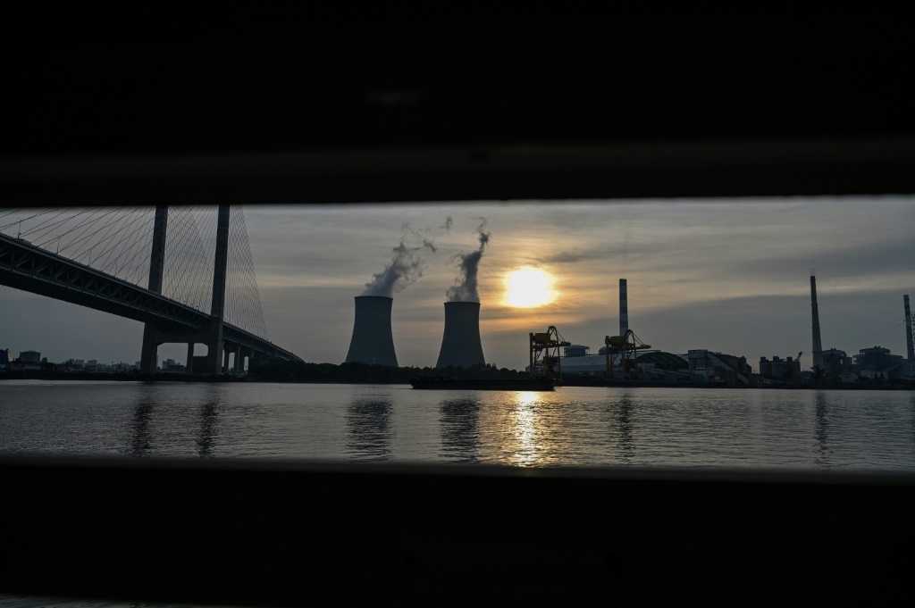 The Wujing coal-electricity power station seen from a ferry window in Minhang district of Shanghai on August 22, 2022 -- China's unwillingness to let go of coal stems partly from inefficiencies in its power grid