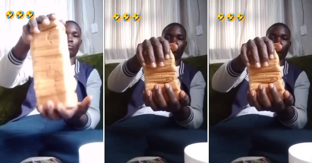 A man crushing an entire loaf of bread