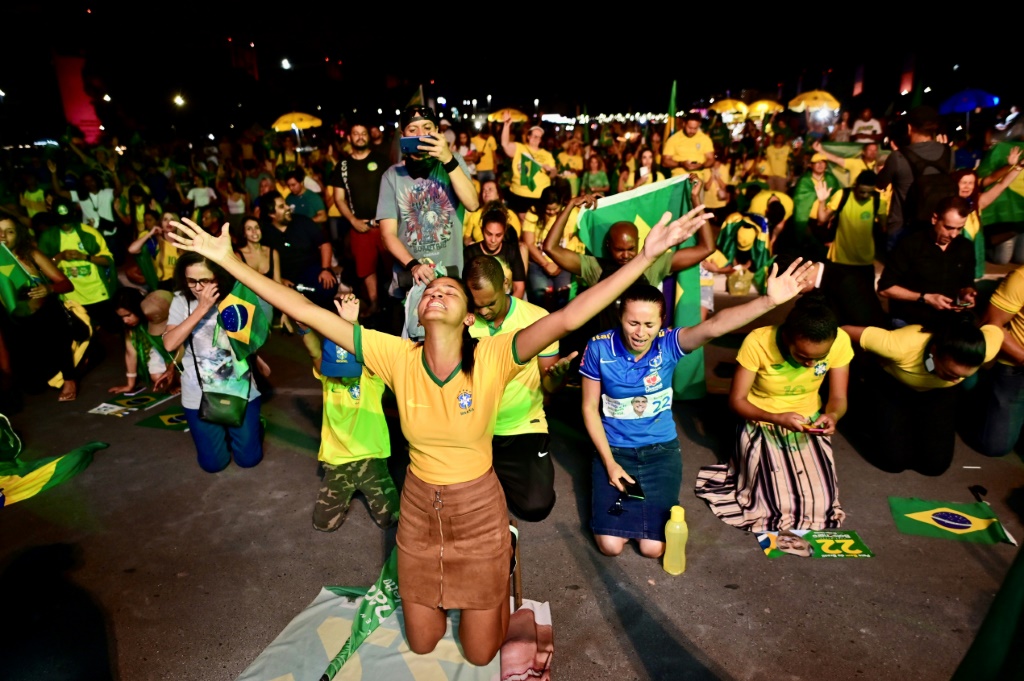 Supporters of Brazilian president and re-election hopeful Jair Bolsonaro prayed -- with no success -- for a political miracle as they watched the vote count in Brasilia