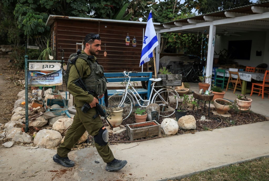 An Israeli soldier in Kibbutz Kfar Aza, which was attacked by Hamas militants, close to the southern Israeli border with the Gaza Strip on October 27, 2023