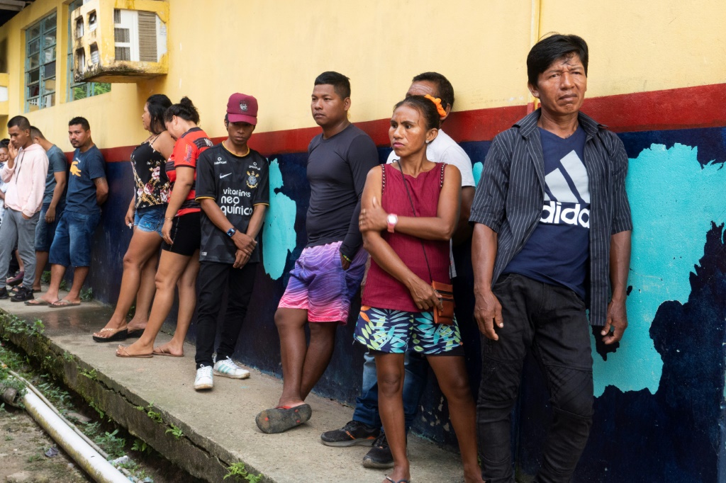 Indigenous Ticuna voters line up to cast their ballots