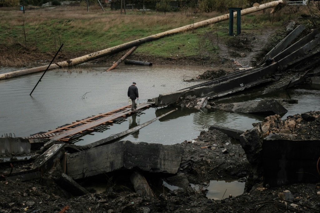 Ukrainian forces smashed the bridge between two sides of the town of Bakhmut to deny its use to the Russians, but residents on the east bank are struggling