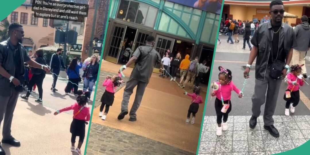 People stare as father uses leash to keep his daughters at arms length