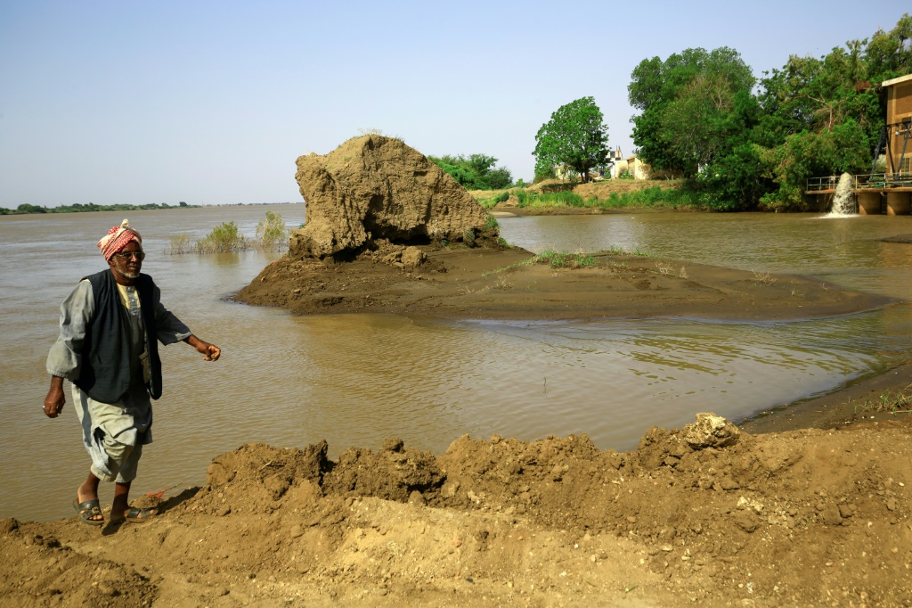 Nature's fertiliser: a farmer walks on the silt-rich bank of the Nile in Gezira state, Sudan