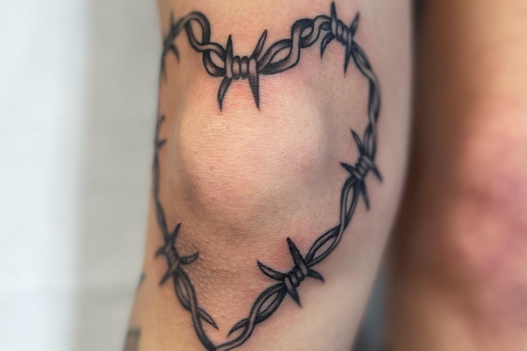 Barbed wire knee tattoo