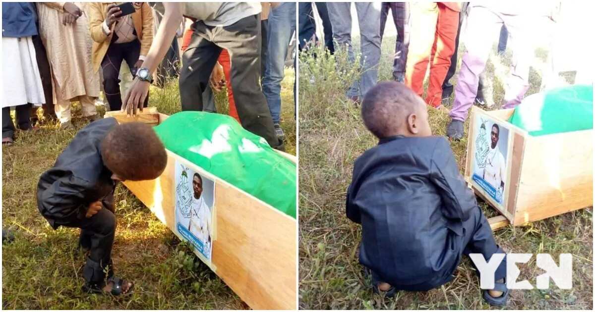 Photo of little Nigerian boy staring at his late father's photo during burial goes viral