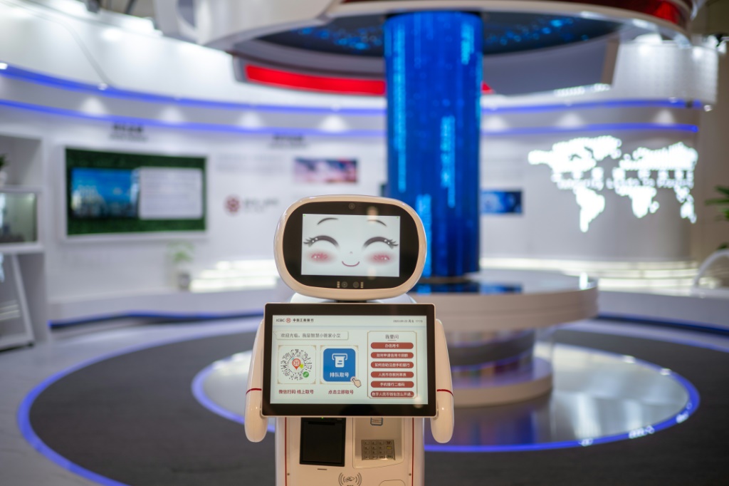 A robot greets visitors at  a bank in the Asian Games media centre