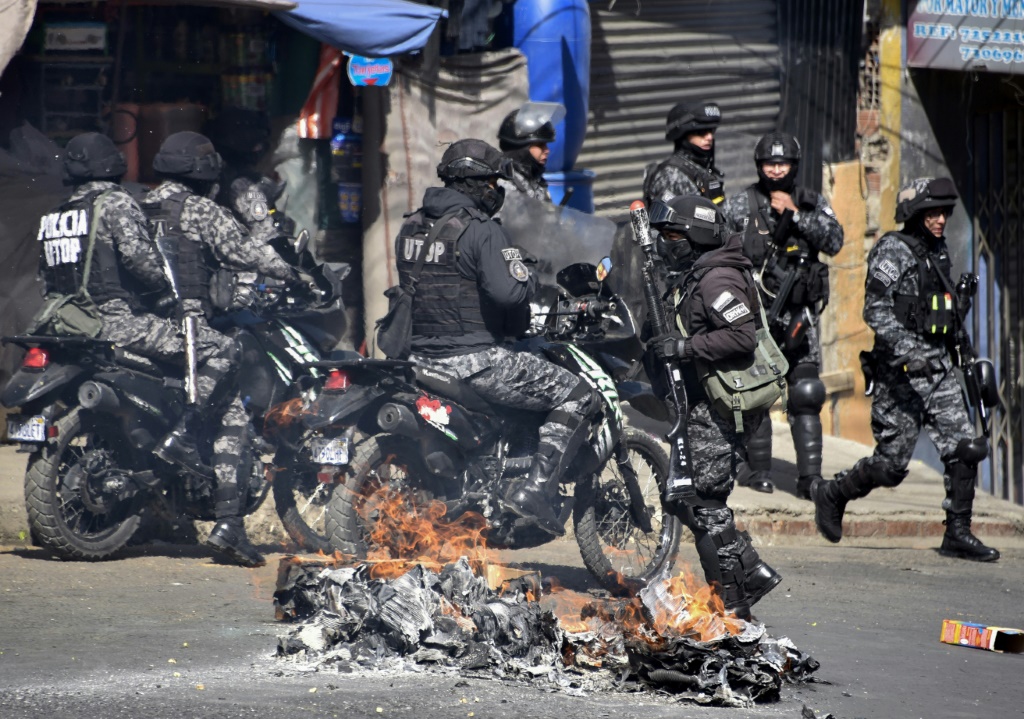 Riot police clash with coca leaf growers during a protest march in La Paz, on August 2, 2022