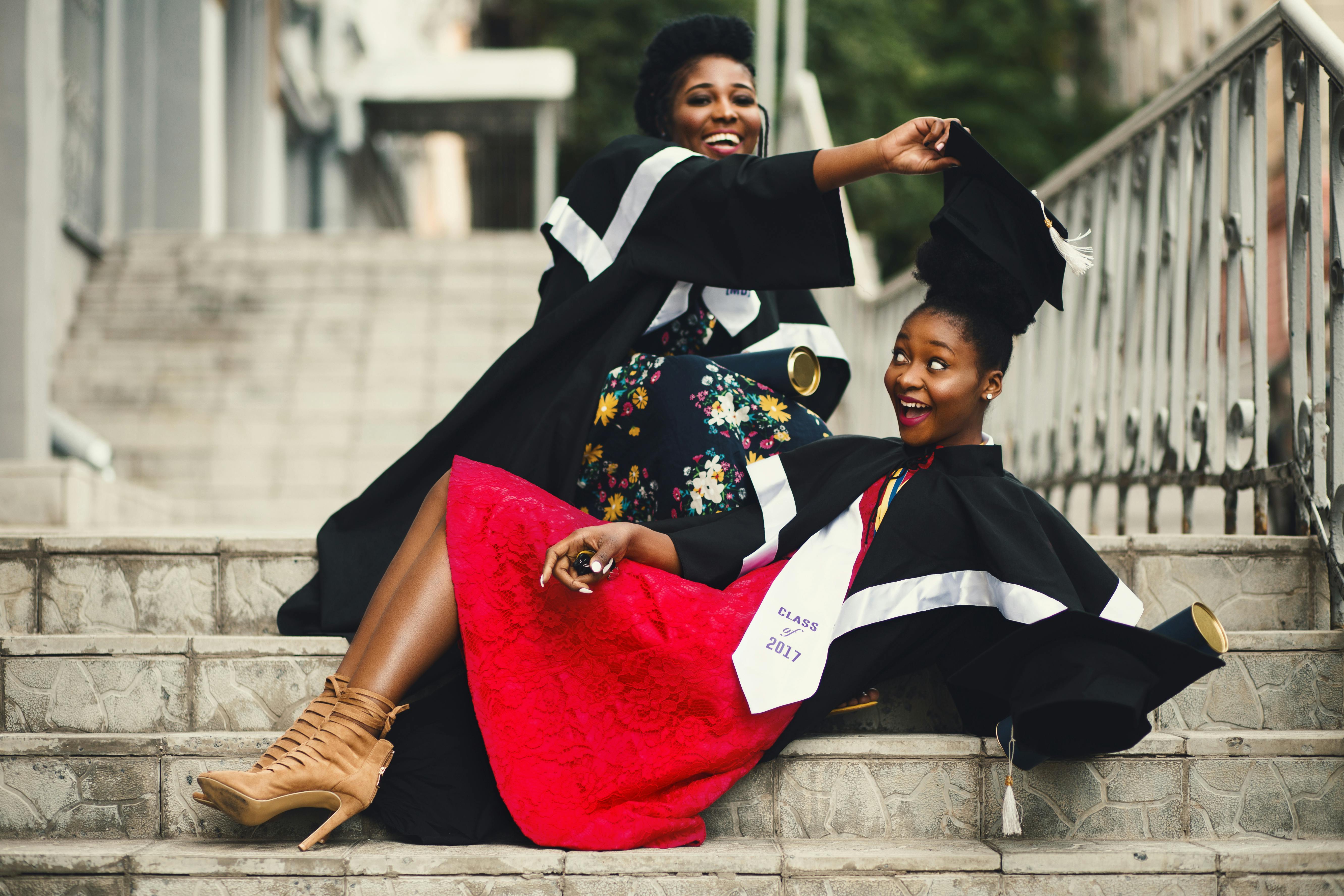 Two students in graduation gowns