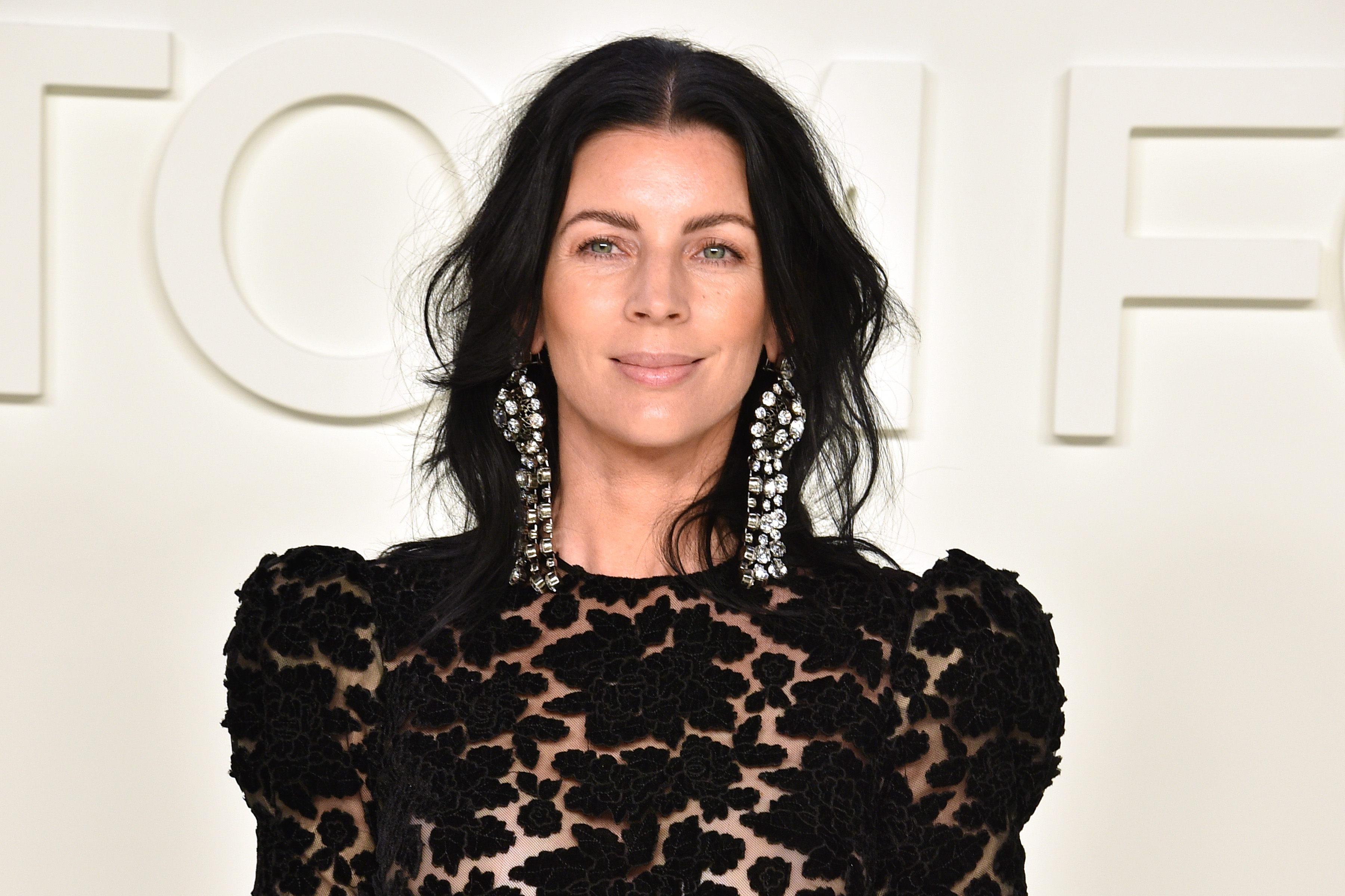 Liberty Ross poses against a white background in Los Angeles, California