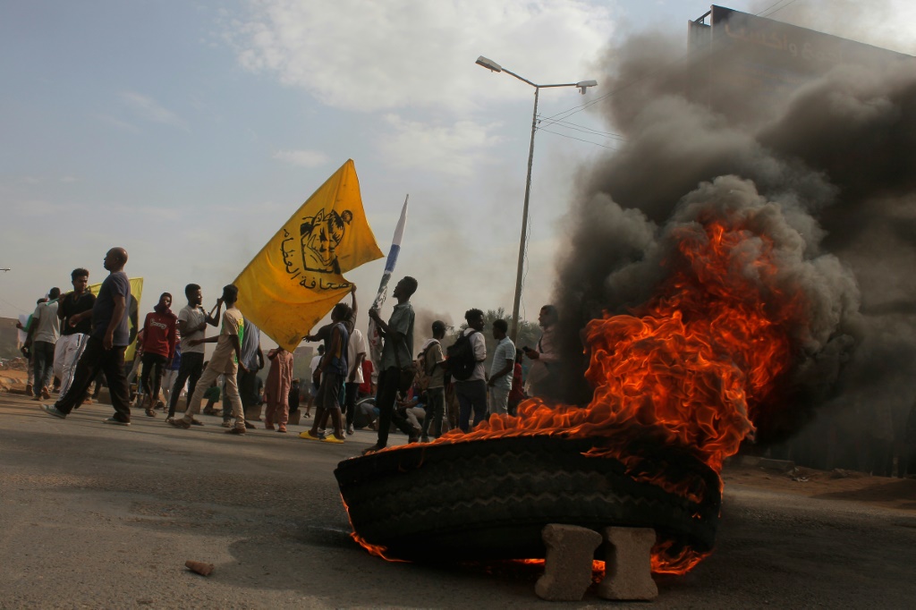 Sudanese protesters block a street in the capital Khartoum last week, as demonstrations against last year's coup persist