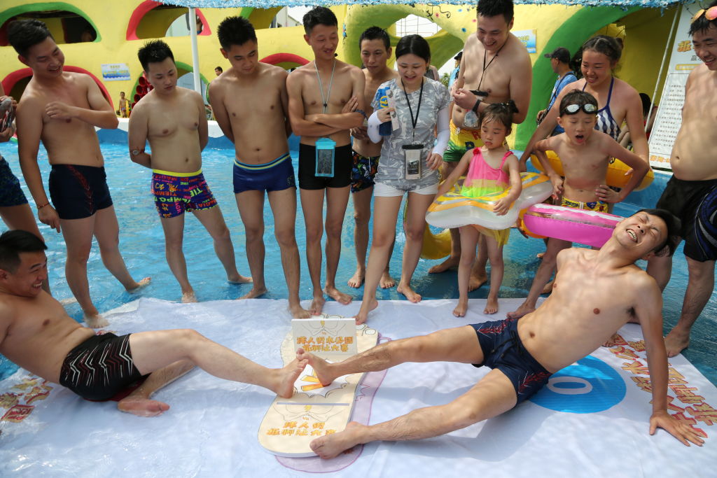 People compete in toe wrestling in Chongqing, China