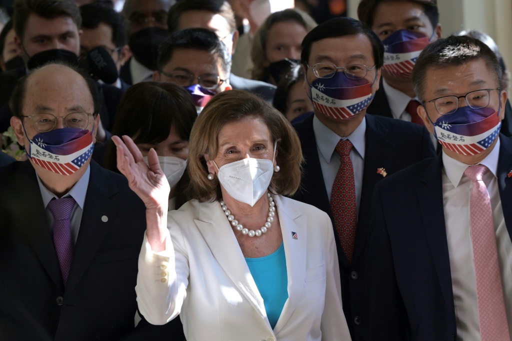 US House Speaker Nancy Pelosi waves to journalists during her arrival at the parliament in Taipei on August 3, 2022