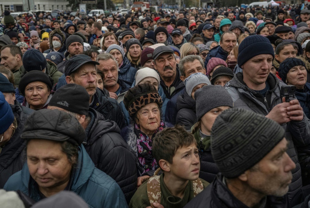 Local residents wait at a food distribution center in Kherson