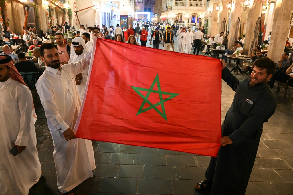 In Doha's Souq Waqif, Arab fans display Morocco's flag