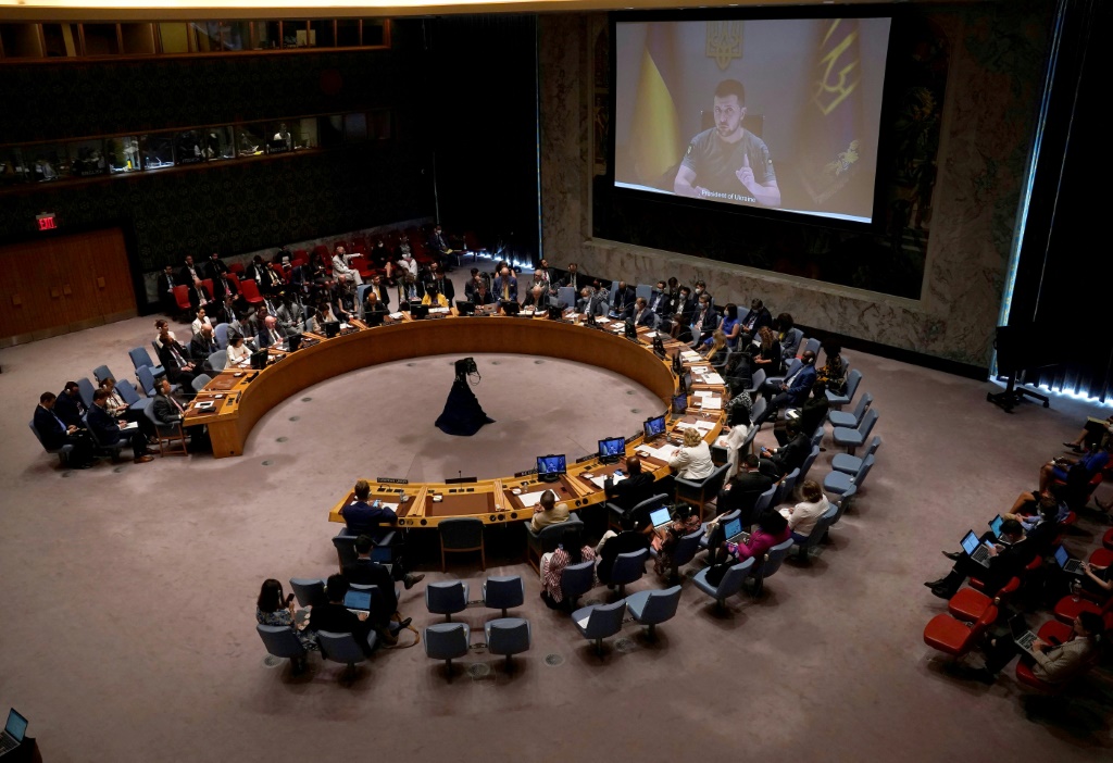 Ukrainian President Volodymyr Zelensky appears on screen as he addresses the UN Security Council meeting on Ukraine in New York on August 24, 2022