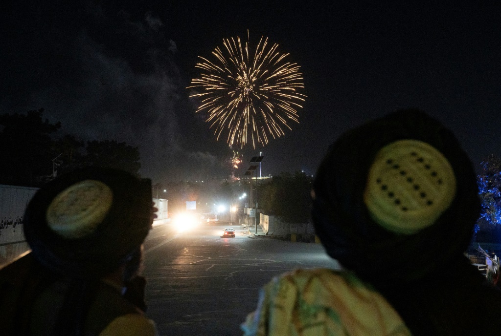 Taliban fighters set off fireworks in the skies over Kabul as they celebrate the first anniversary of the US troop withdrawal