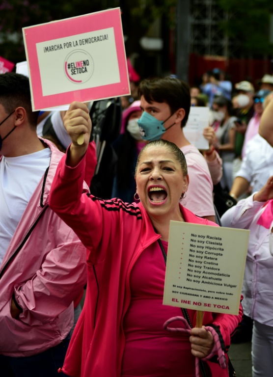 A woman shouts slogans during a march against  government plans to restructure the National Electoral Institute in Mexico City on November 13, 2022
