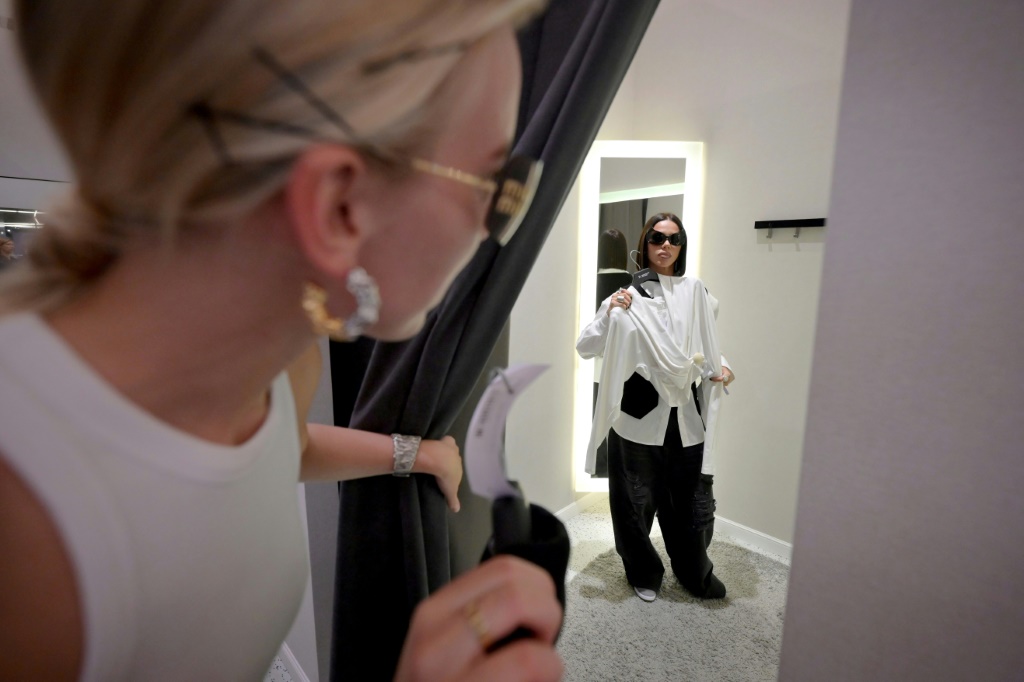 A woman tries on clothes in a fitting room at a shopping centre in Moscow