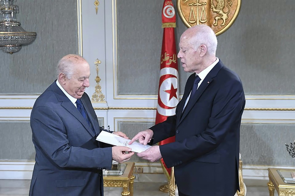 Tunisian President Kais Saied (R) has published an amended version of a draft constitution after an earlier iteration was criticised for the level of power it gave his office