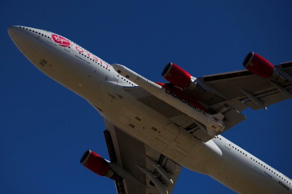 The Virgin Orbit 'Cosmic Girl' -- a modified Boeing 747 carrying a LauncherOne rocket under its wing -- takes off from Mojave Air and Space Port in 2021
