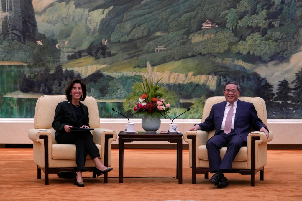 China's Premier Li Qiang (R) speaks with US Commerce Secretary Gina Raimondo in Beijing in August 2023