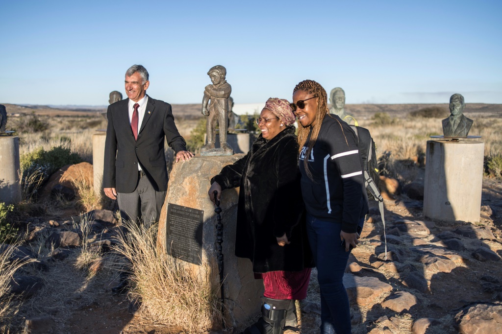 VIP guests Gaboilelwe Moroka and Bhelekazi Mabandla, centre and right, view Orania's Afrikaner statues. On the left is Louis Bothma, a historian and part of the welcoming committee