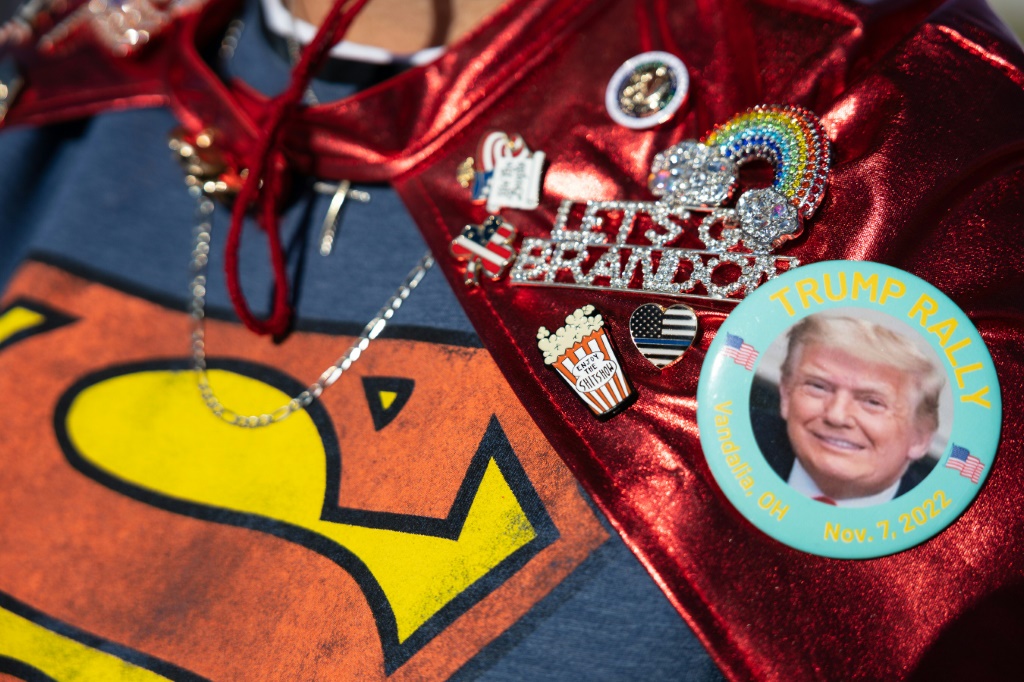A supporter wears pins supporting former US president Donald Trump while arriving at a rally in Vandalia, Ohio, on November 7, 2022 -- the eve of US midterm elections