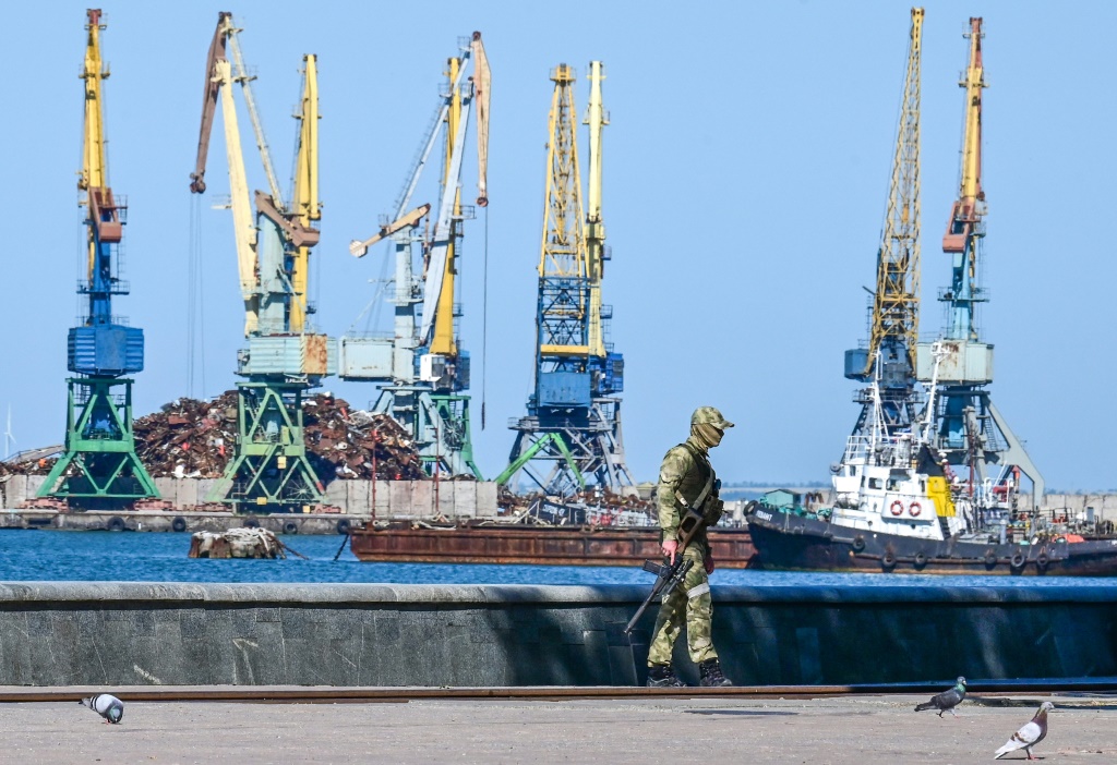 A Russian serviceman patrols on the promenade in Berdyansk in mid-June amid the ongoing Russian military action in Ukraine
