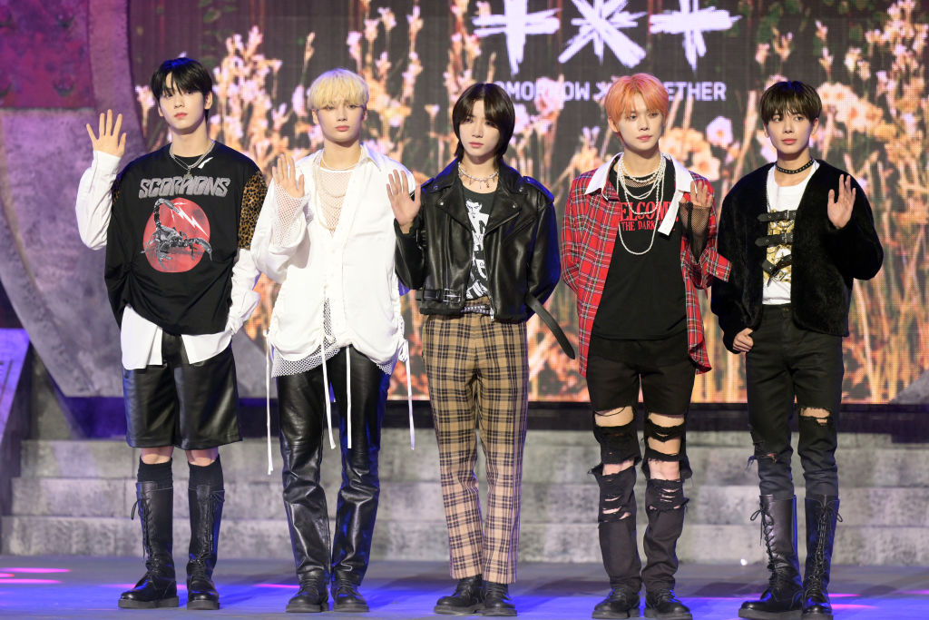 Tomorrow X Together, one of the most popular K-pop groups globally, pose for a photo on stage