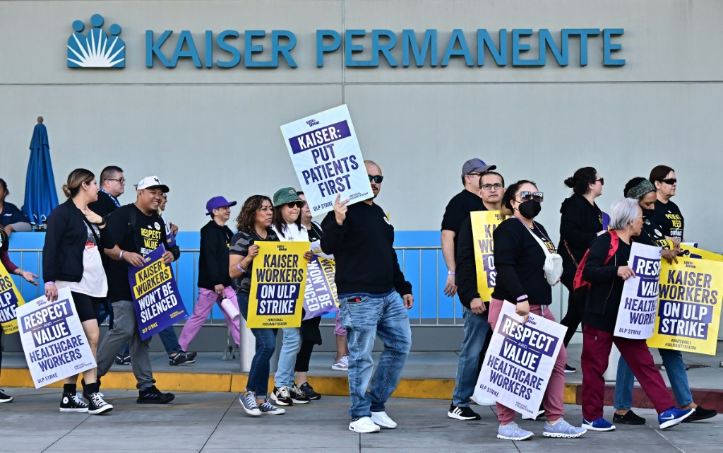 Kaiser Permanente and unions representing thousands of workers have reached a tentative deal to end industrial action, the two sides say