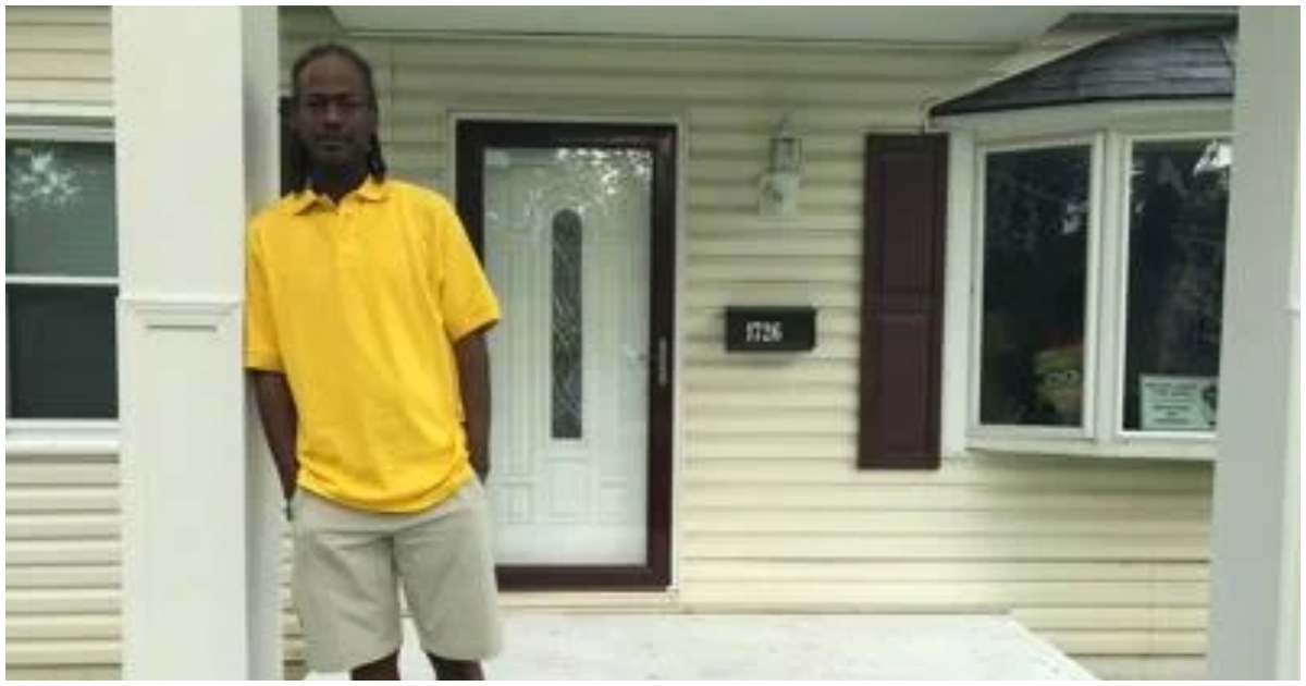A Landlord stands in front of his house