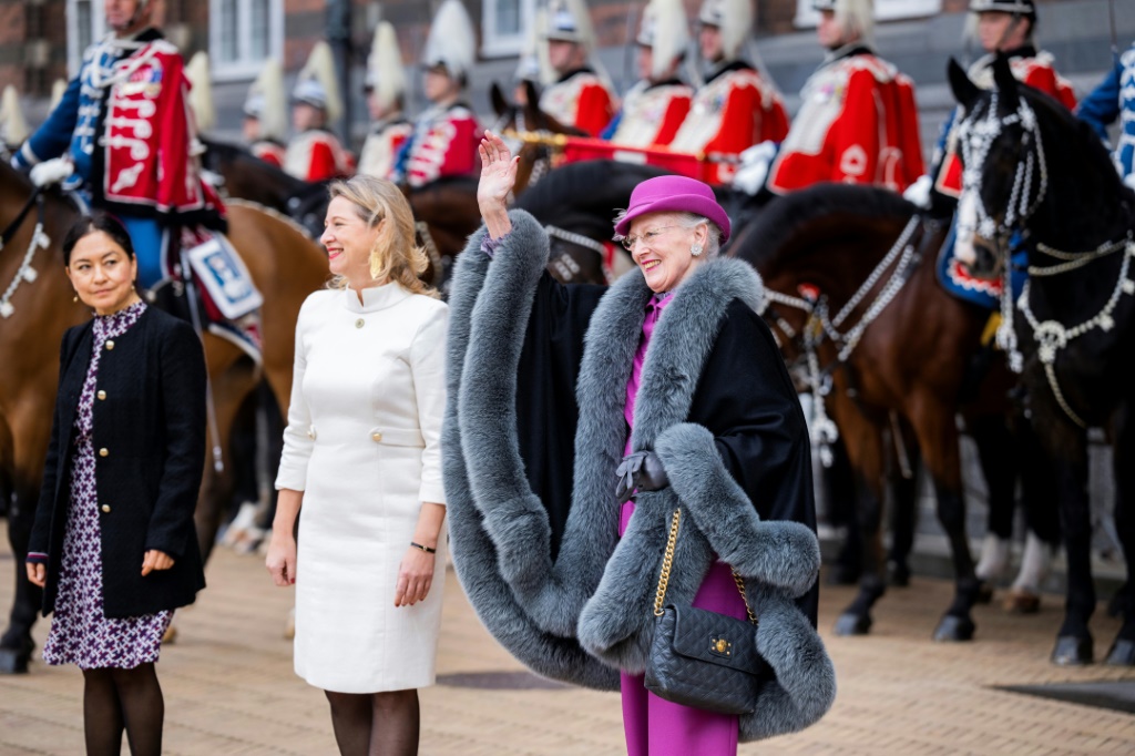 Queen Margrethe II waves to onlookers as she is welcomed by Copenhagen's Mayor Sophie Haestorp Andersen at city hall