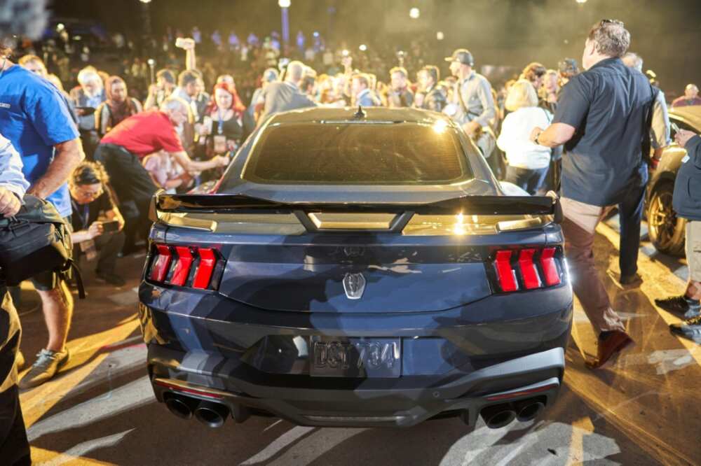 Crowds surround the new Ford Mustang Dark Horse following its debut at the North American International Auto Show in Detroit, Michigan on September 14, 2022