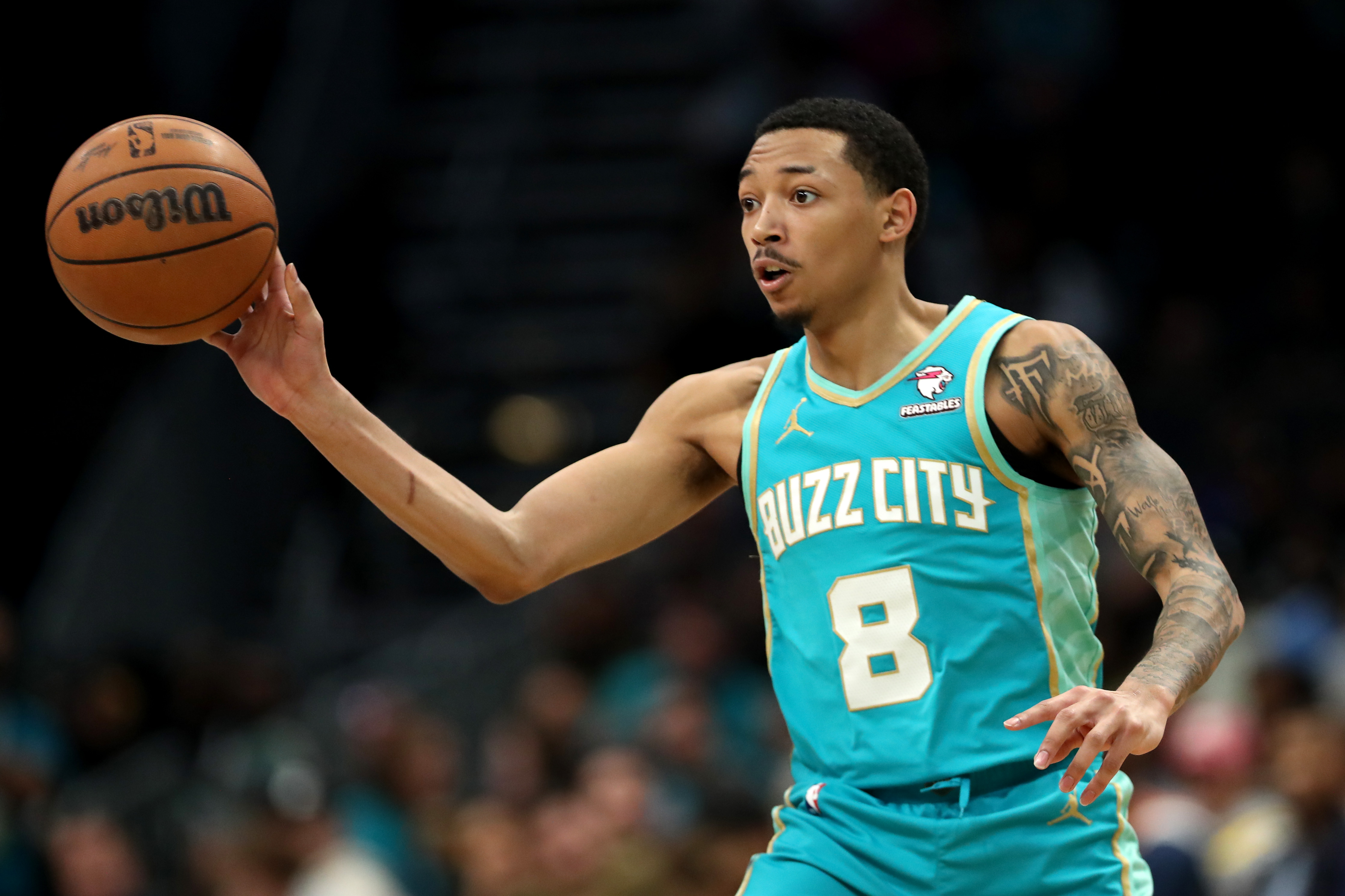 Nick Smith Jr. of the Charlotte Hornets passes the ball during the second half of an NBA game