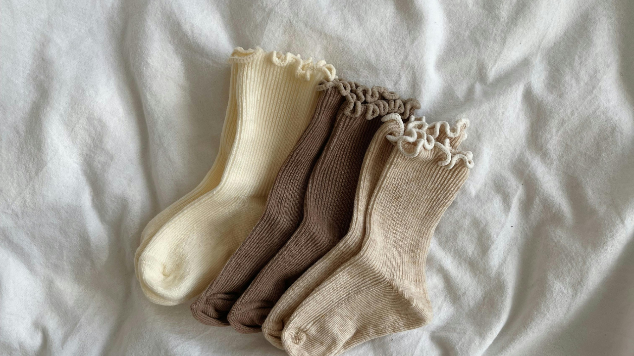 Various pairs of socks on bed