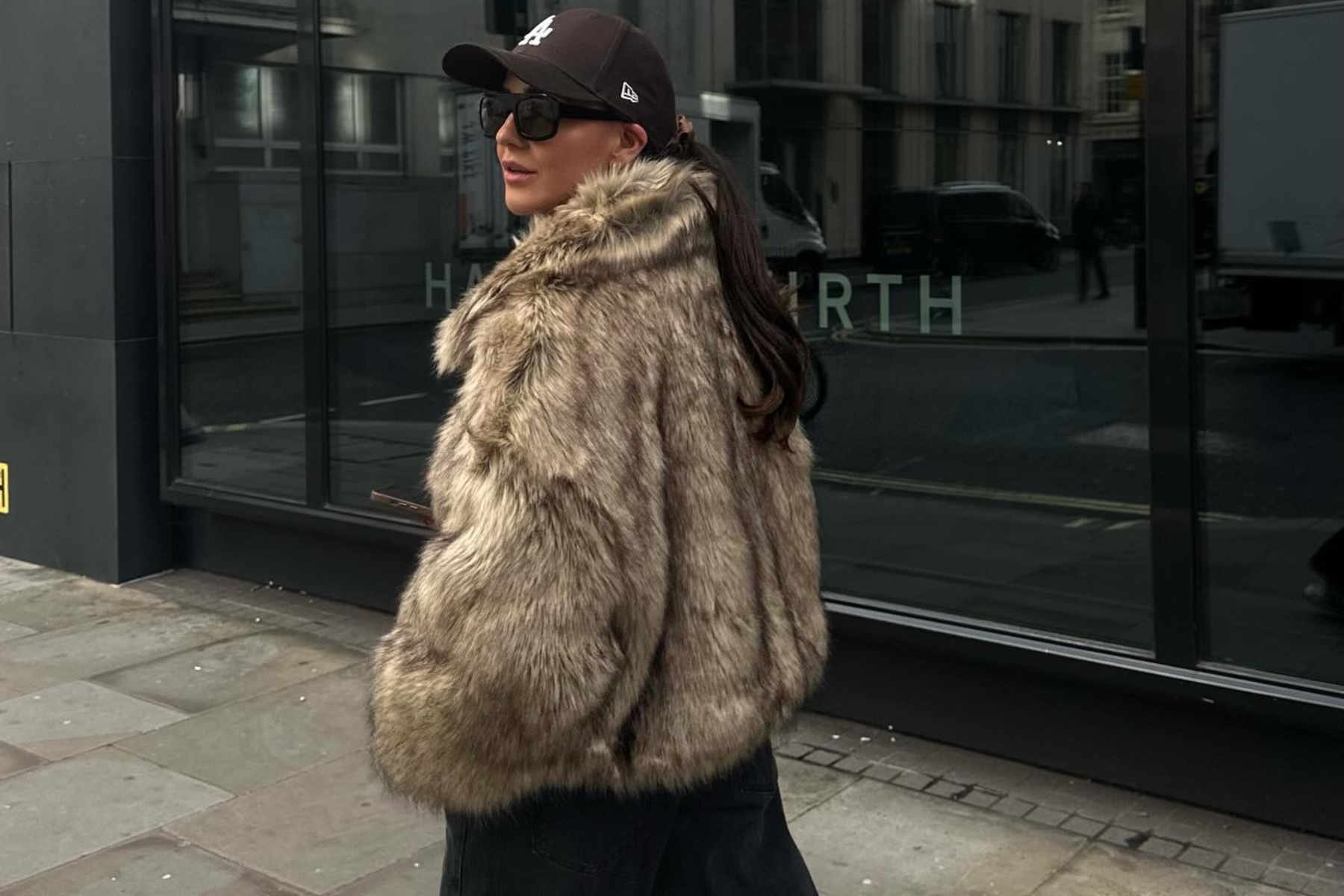 A woman is wearing a fur jacket
