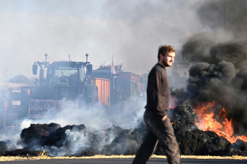 Some French motorways were blocked on Friday with burning bales of straw