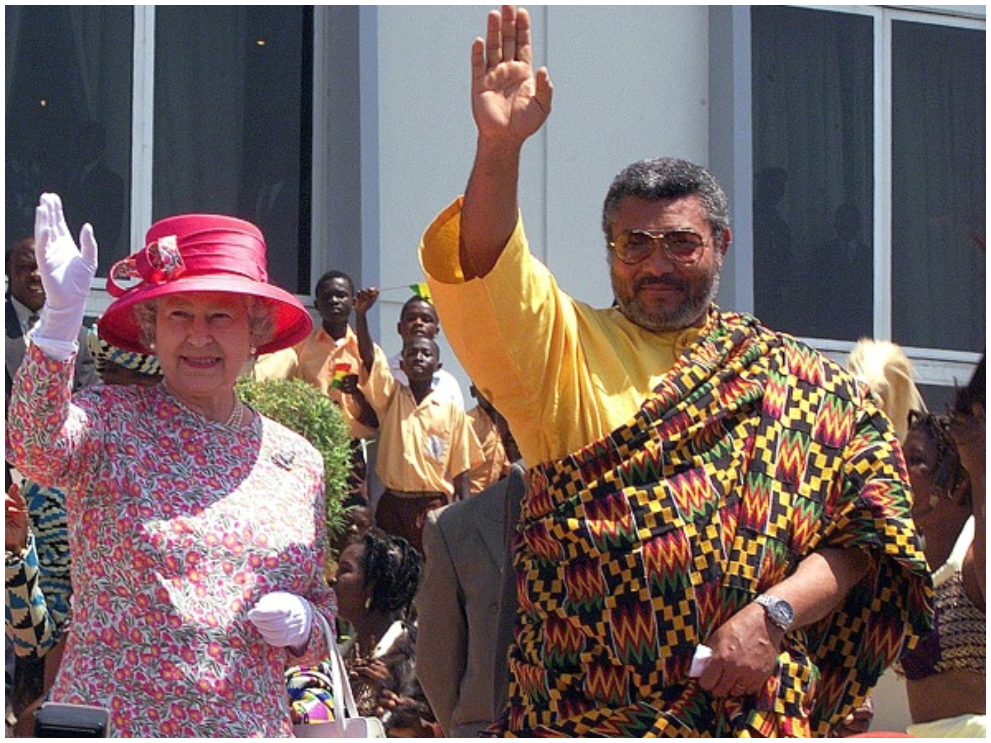 Queen Elizabeth and Rawlings wave shortly after the Queen addresses Parliament.
